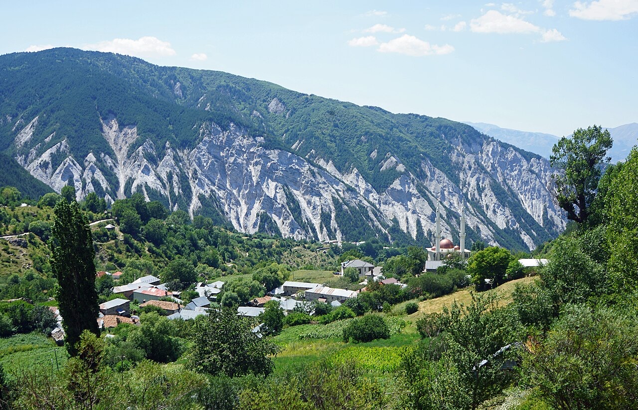 The village Radomirë in Dibër in Northern Albania with mountain Majë e Vleshës in the background