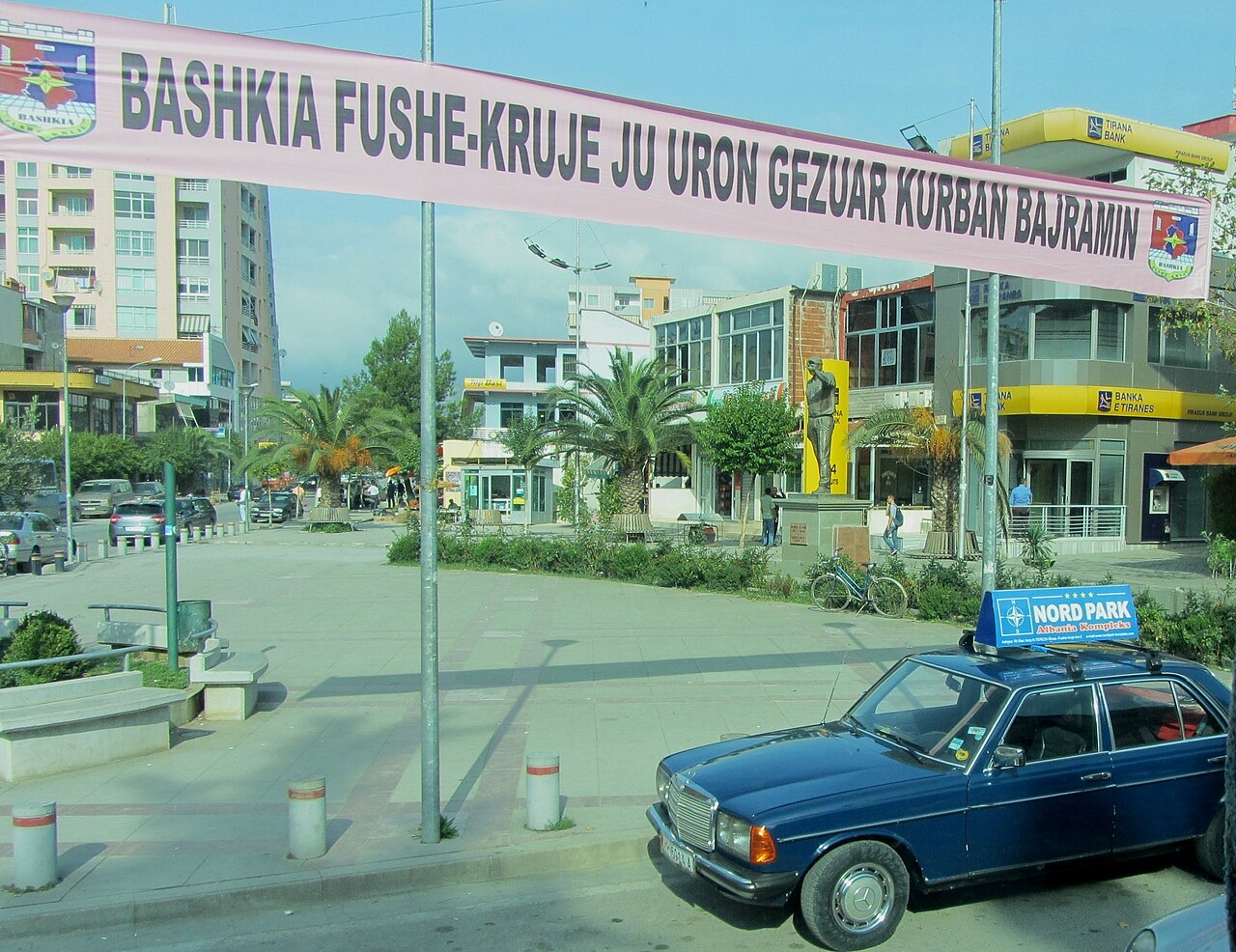 Bush Square in Fushë-Krujë, Albania seen through a bus window