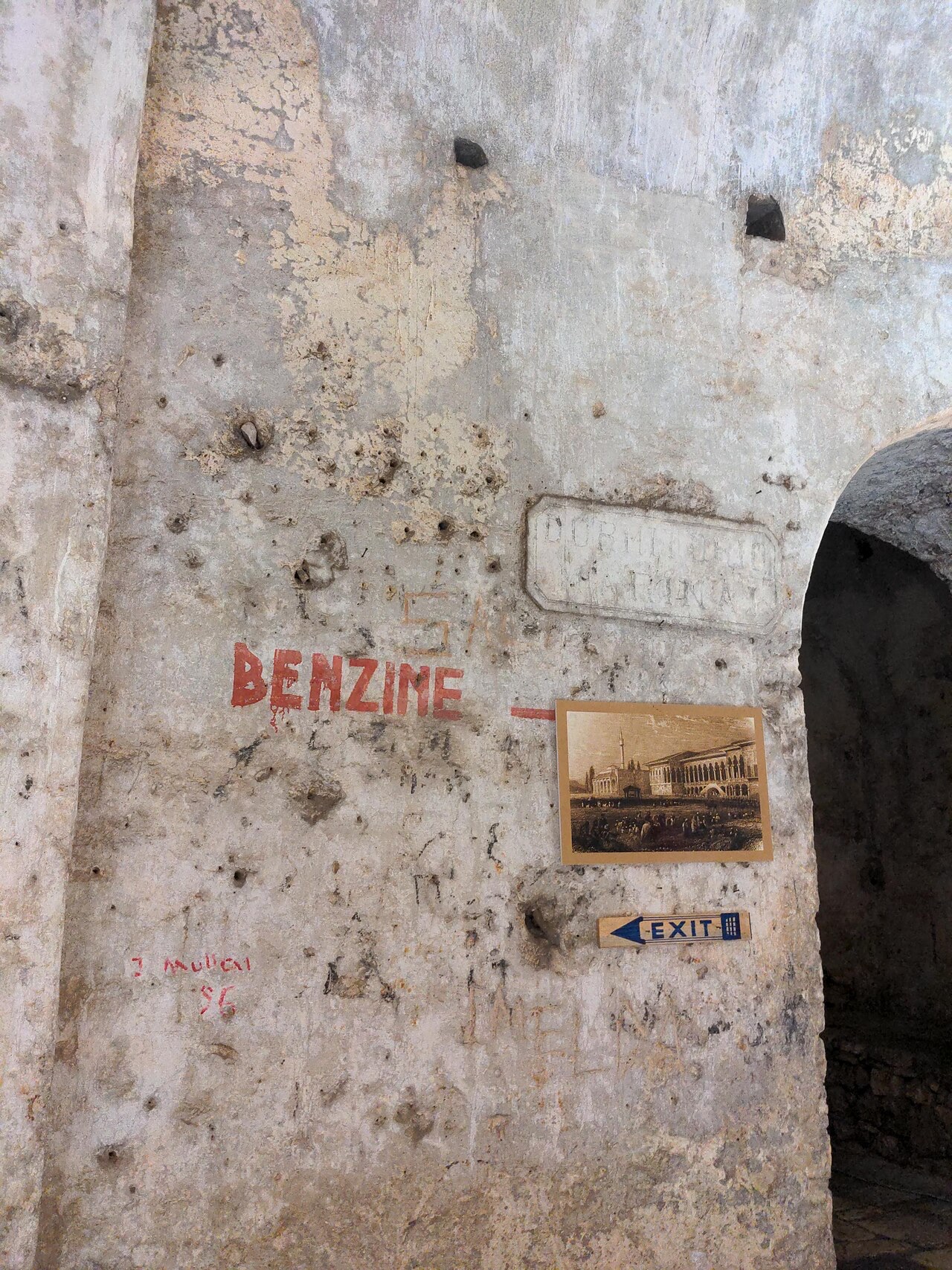 Sign showing that benzin (gas) was stored inside the Castle of Porto Palermo.