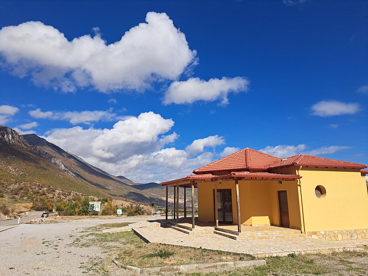 Infopoint building at entrance of Prespa National Park next to the welcome sign, in Pustec, Albania