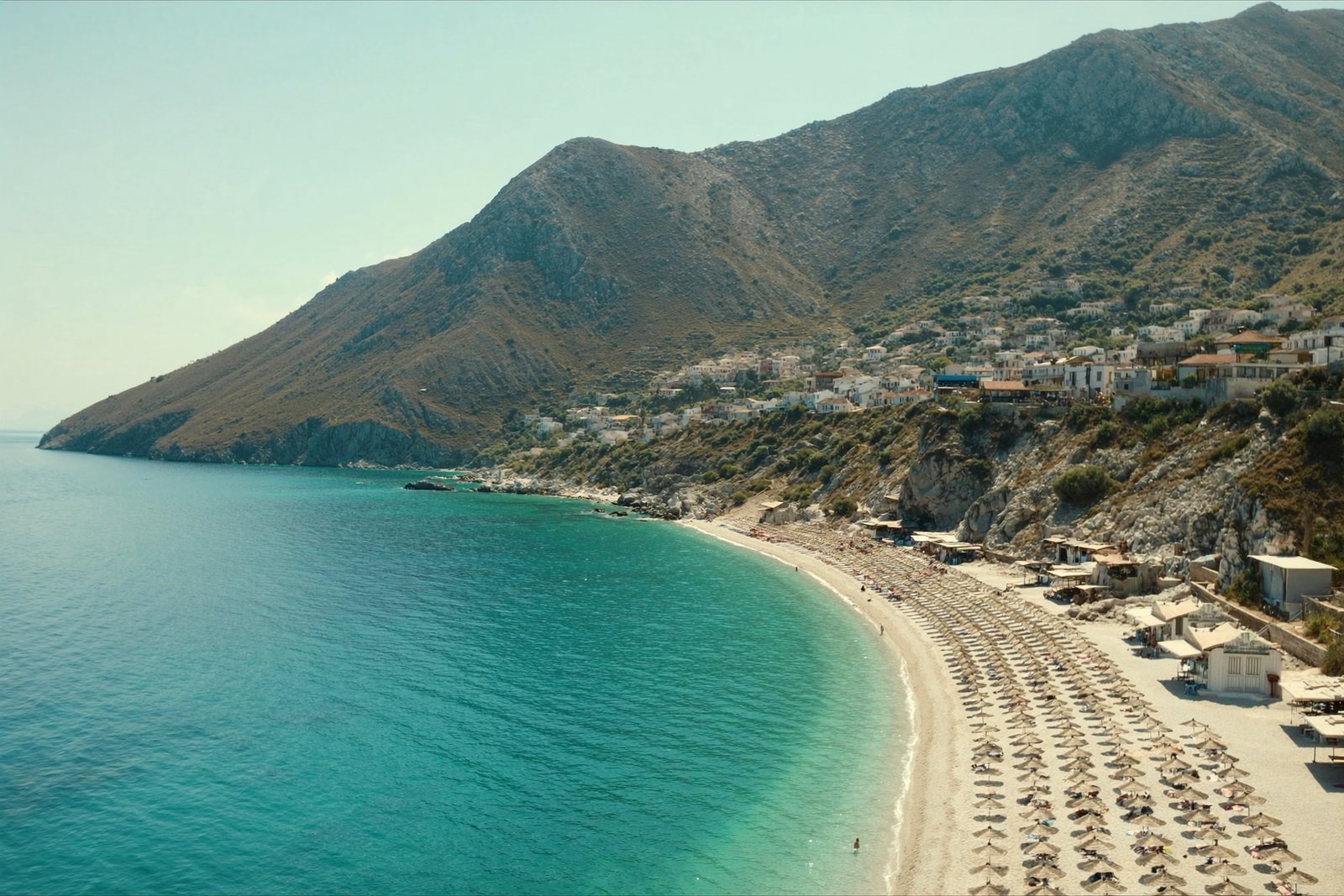Dhërmi Beach: a white pebble shore under the Ceraunian ridge
