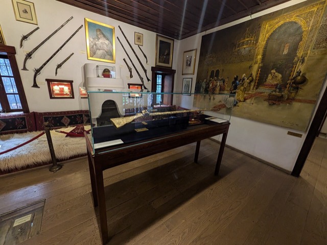 Interior photo of the Ali Pasha Museum on Ioannina island featuring weapons displays.