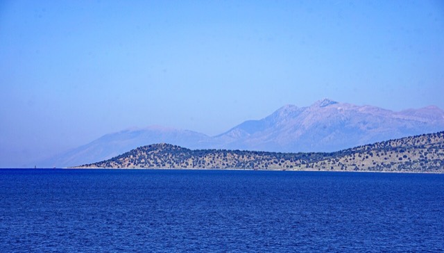 Qefali Cape (Kepi i Qefalit), West of Sarandë, Albania, with its lighthouse – in the background Maja e Çikës and Llogara Pass, some boats off the cape