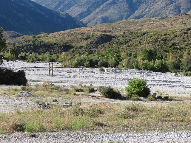The Kardhiqit River, Albania, near Kardhiq, Gjirokastër County. A pipeline can be seen spanning the river.