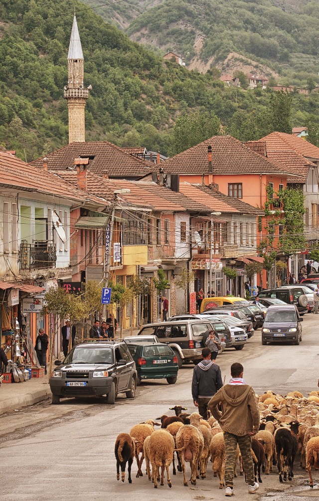 The center of Peshkopi, Albania, the Tercilio Cardinal Street with tha bazaar (Pazar), the minarey of the Old Mosque (Xhamia e Vjetër) in the background