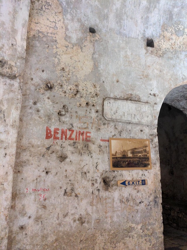 Sign showing that benzin (gas) was stored inside the Castle of Porto Palermo.