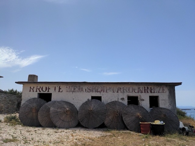 Abandonned building on Porto Palermo, contains former socialist message "Long live the albanian-chinese friendship" (RROFTE MIQESIA SHQIPTARO-KINEZE).