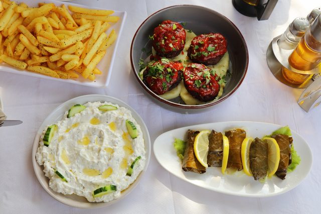 Albanian meze: qofte meatballs, salcë kosi and japrak stuffed grape leaves
