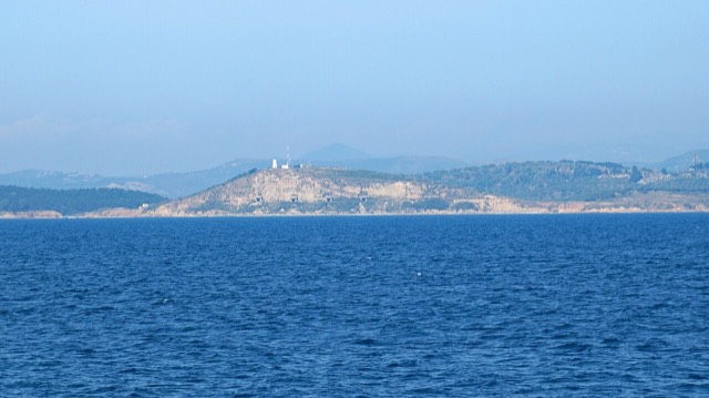 Shoreline West of Zvërnec (Vlorë, Albania) with lighthouse of Treport and bunkers in the cliff